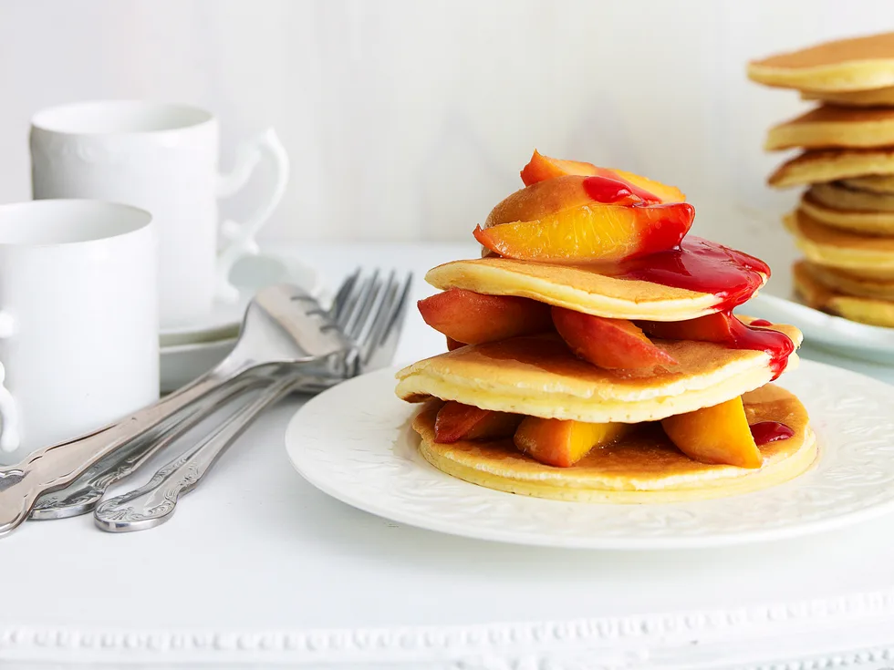 Pancakes with peaches and raspberry puree