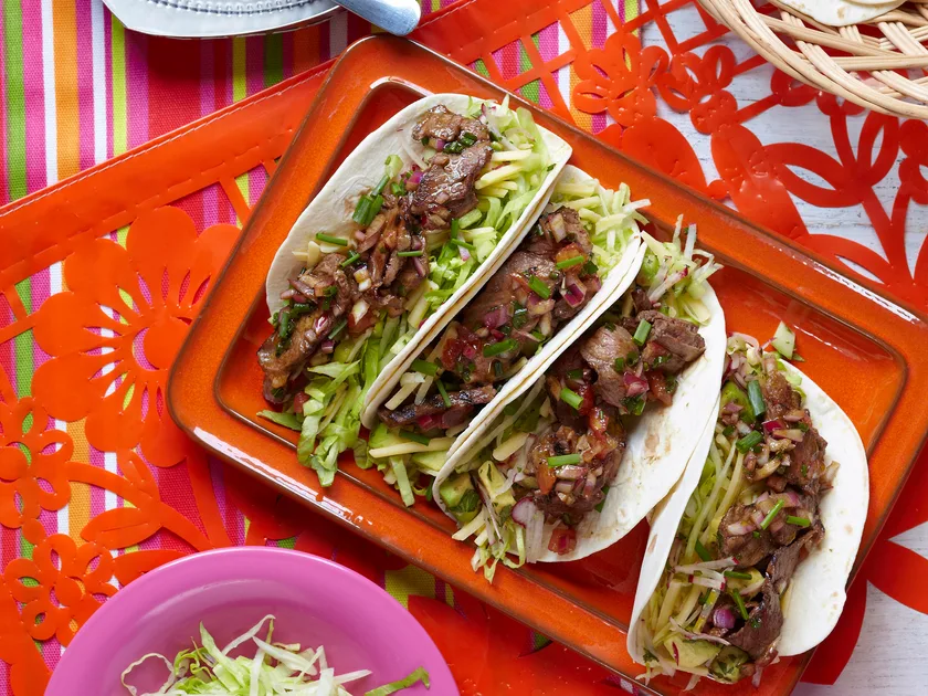 Smoky barbecued beef tacos with tomato dressing