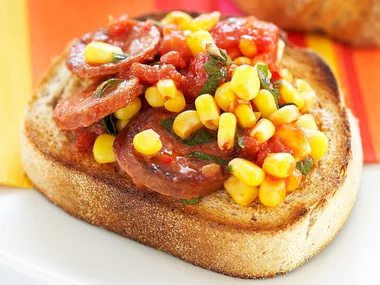 Fried chorizo with tomatoes and corn