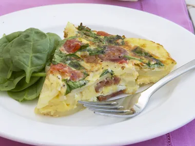 spanish omelet with roasted tomatoes, spinach and chorizo