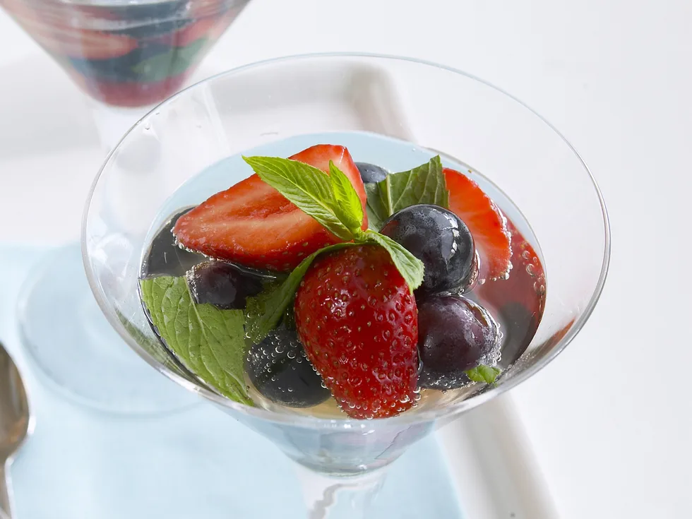 strawberries and grapes in sparkling wine and mint
