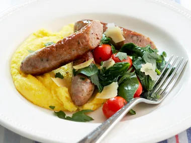 soft polenta with sausages and spinach