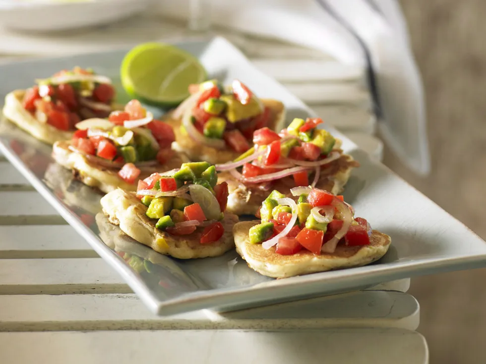 Spicy corn and fish fritters with avocado salsa