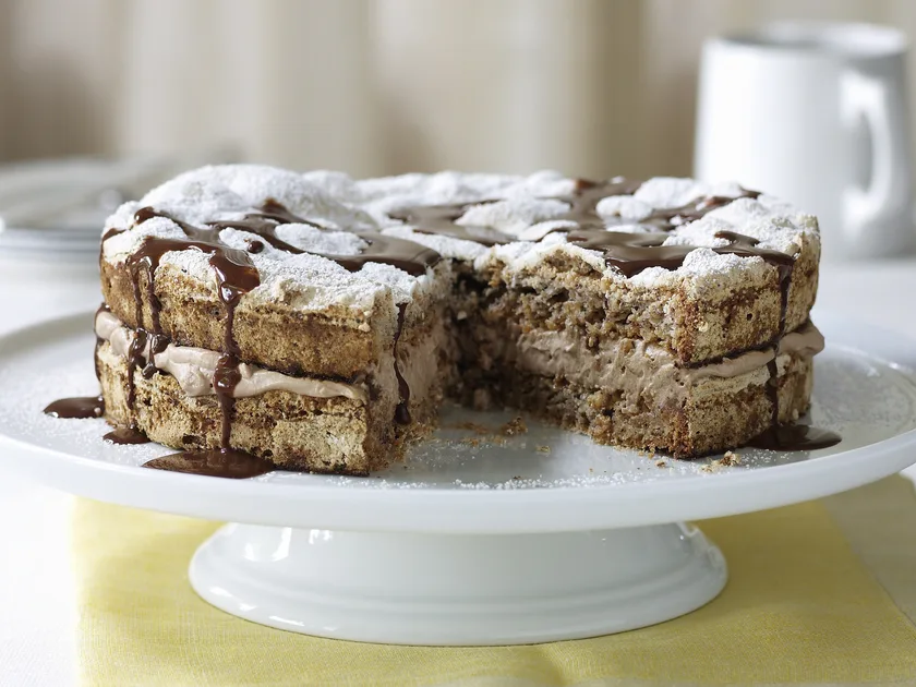 Hazelnut meringue cake with chocolate sauce