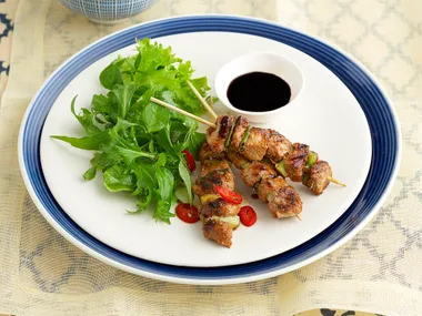 Caramelised pork skewers with asian herbs