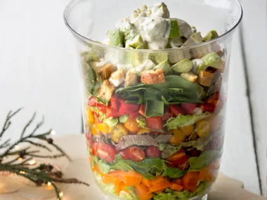 Layered salad with croutons and avocado lime aioli