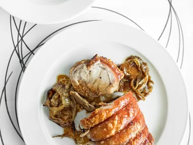 Slow-cooked pork loin with caramelised pears and hazelnuts