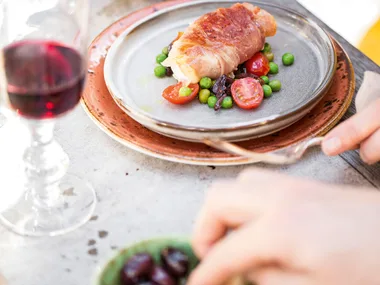 Burrata wrapped in prosciutto with tomato, olive, basil and pea salad