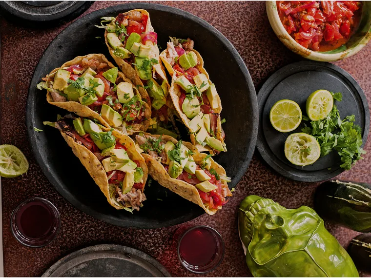 Pulled pork tacos with grilled green chillies and crema