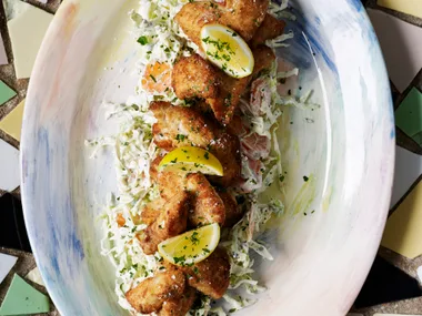 Creamy coleslaw topped with crumbed fish fillets