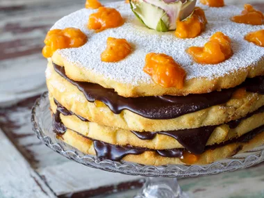 Easter layered vanilla almond sponge cake with apricots and ganache