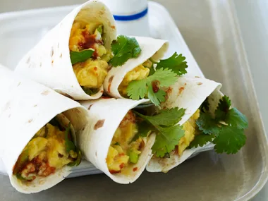 Cheesy scrambled eggs rolled in tortillas