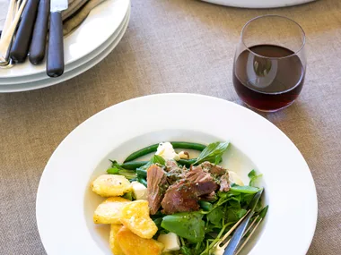 Slow-roasted lamb with peppery salad and mint vinaigrette