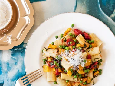 Rigatoni with cherry tomatoes, yellow peppers and baby peas