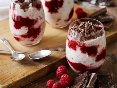 Smashed chocolate meringues, chocolate cream and raspberries