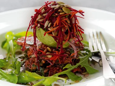 Spicy carrot and beetroot fritters with avocado and seed salad