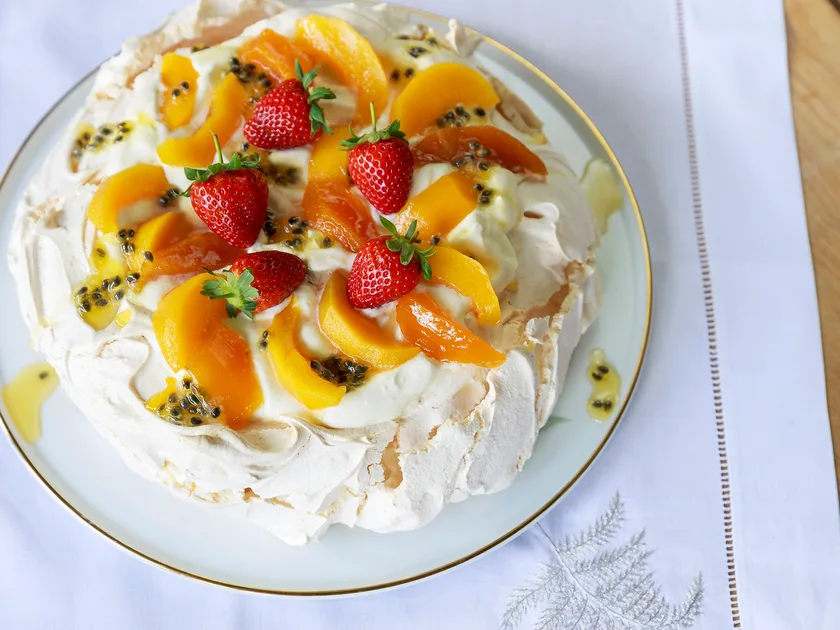 Classic pavlova with spiced peaches and preserved passionfruit