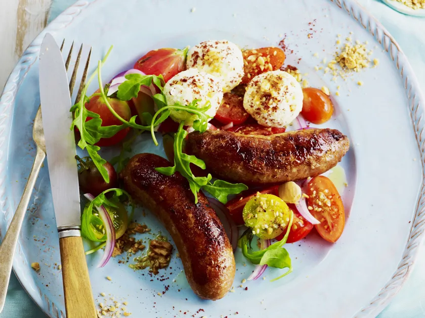 Lamb sausages with labne, dukkah and tomato salad