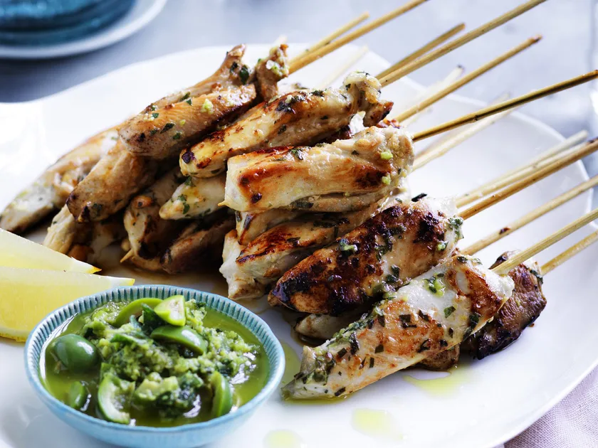 Chicken skewers with green olive dressing