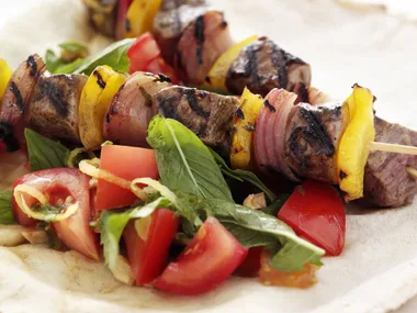 Souvlakia with tomato, almond and mint salad