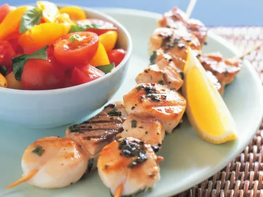 Scallop and fish skewers with tomato salad