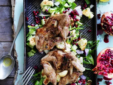 char-grilled quail with cauliflower and pomegranate salad