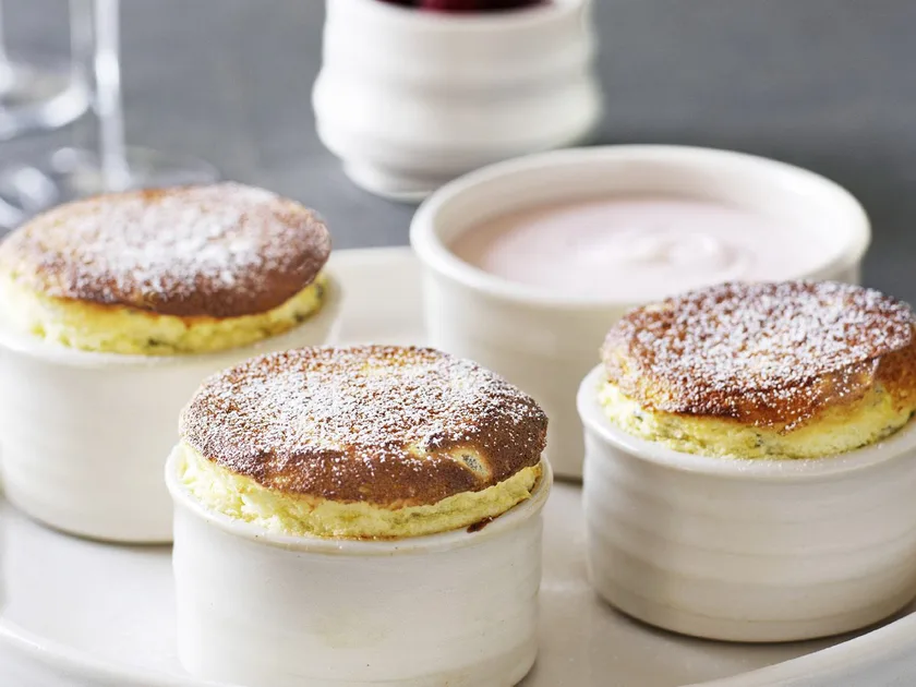 Hot passionfruit soufflés with raspberry cream