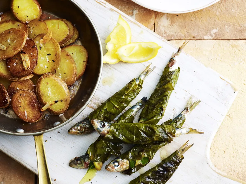 Barbecued vine-leaf-wrapped sardines with garlic potatoes
