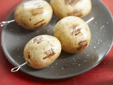 skewering potatoes