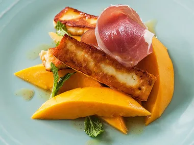 Pan-fried haloumi with papaya, lemon and prosciutto