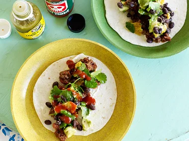 Soft flour tacos with chilli beef sauce and black bean salad