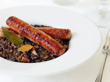 Stewed lentils with smoked bacon and pork sausages