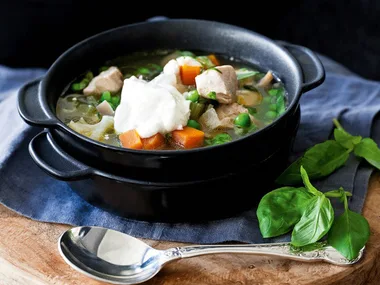 Chicken ragout soup with peas and sour cream