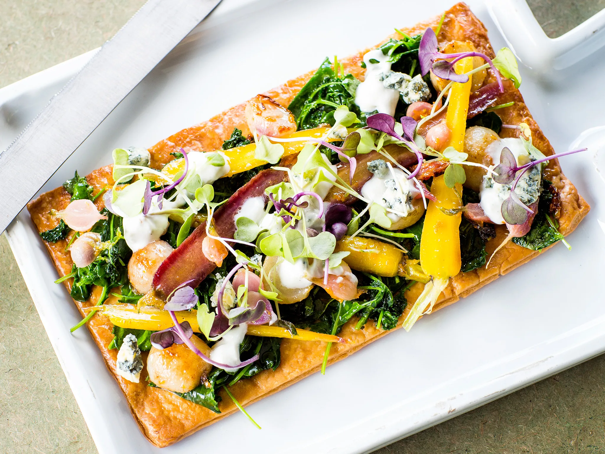 Glazed baby vegetable tart with creamy blue cheese
