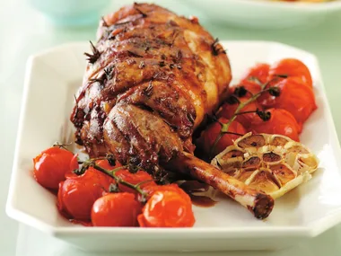 Roast lamb with anchovies, garlic and vegetables