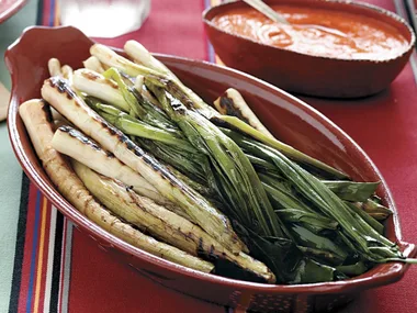 Grilled leeks and green onions with romesco sauce