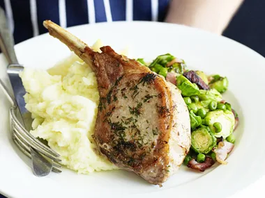 Pork cutlets with bacon, brussels sprouts and peas