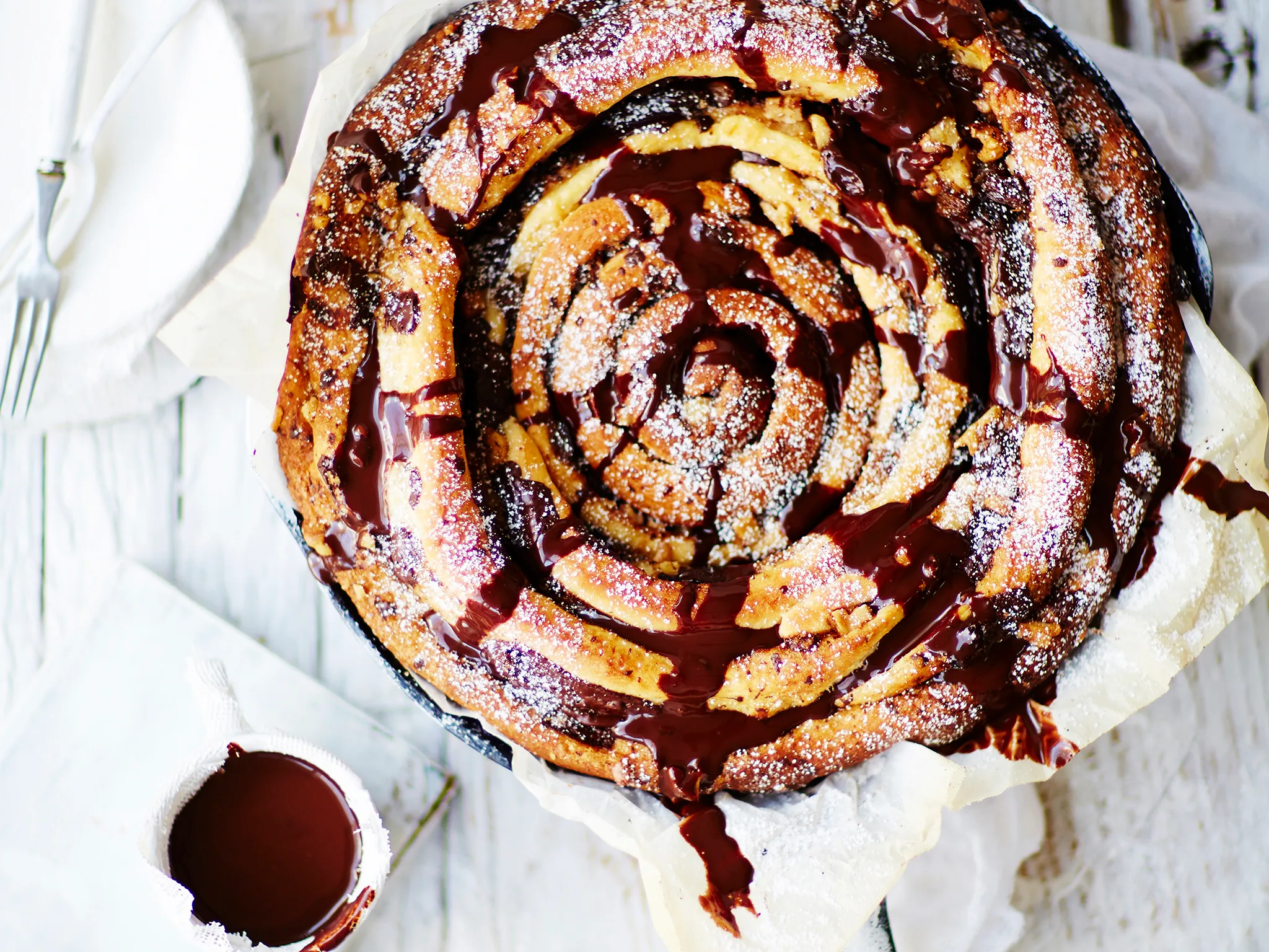 Giant skillet chocolate and cinnamon spiral with chocolate sauce