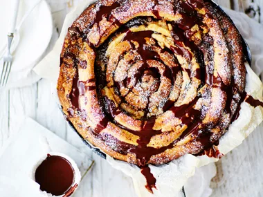 Giant skillet chocolate and cinnamon spiral with chocolate sauce