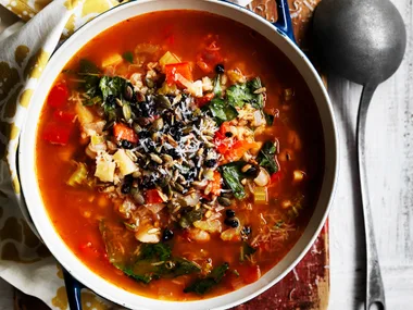 Barley and vegetable soup with crunchy seeds