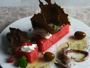 George Calombaris’ grilled calamari, watermelon, olives, goats curd, crispy vine leaves