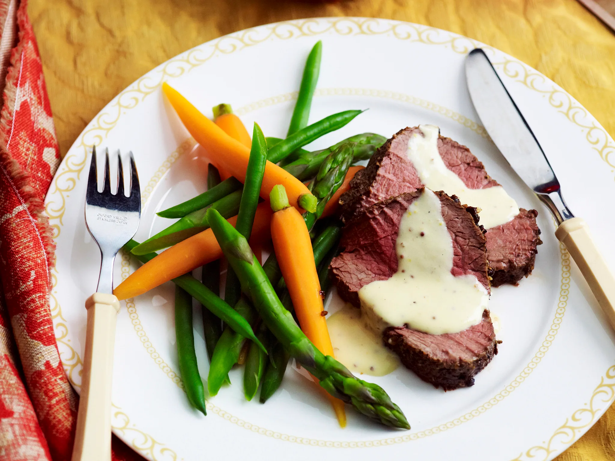 Pepper-crusted beef with mustard and crème fraîche sauce