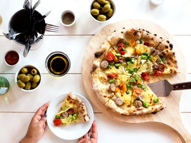 Pork sausage pizza with tricolour tomatoes, broad beans and fennel