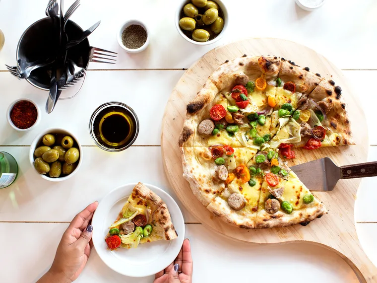 Pork sausage pizza with tricolour tomatoes, broad beans and fennel