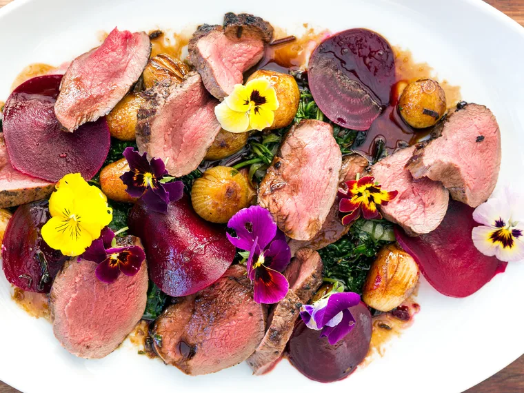 Roast venison loin, shaved beets, balsamic onions & wild greens