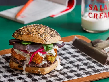 Crumbed avocado sandwich with smashed black beans & pink pickled onions