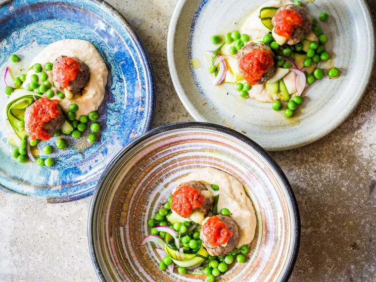 Mozzarella-stuffed meatballs with pea-mint courgette salad and white bean purée