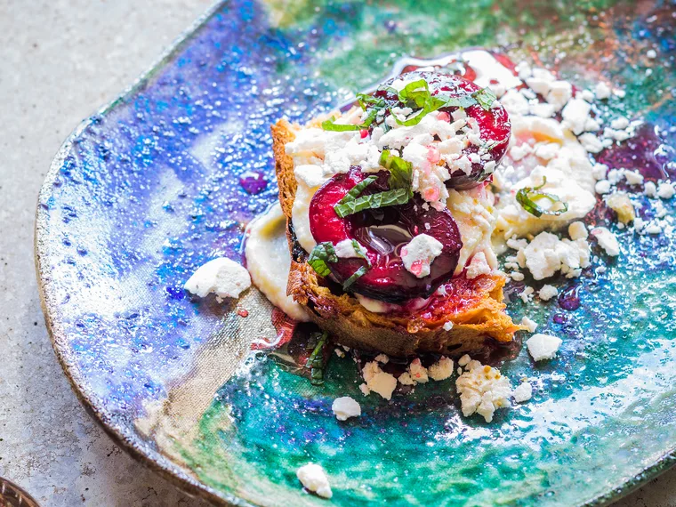 Grilled plums on toasted panettone with honeyed ricotta and mint syrup