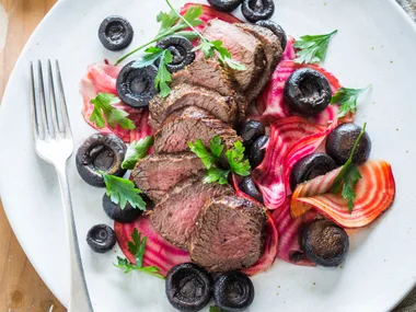 Peppered venison with candied beets and pickled mushrooms
