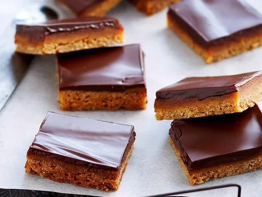 cut up squares of caramel slice
